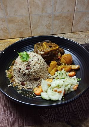 A picture of Ossobuco Stew Served with Jamaican Beans in Rice.