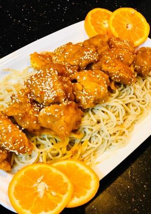 A picture of Orange chicken with noodles.