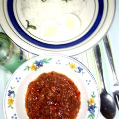 A picture of Rice with Tomato sauce.