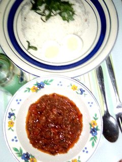 A picture of Rice with Tomato sauce.
