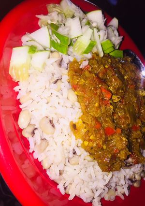 A picture of Rice n beans wit onion sauce.