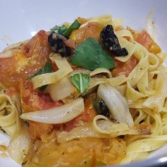 A picture of Pasta with oven-roasted tomato and onions, basil, black garlic and balsamic vinagre.