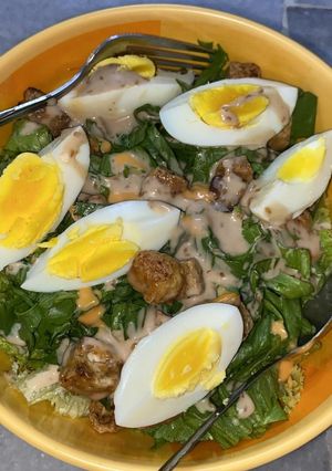 A picture of Chicken Caesar-Style Salad with Boiled Eggs.