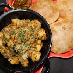 A picture of Jeera Aloo with Poori.