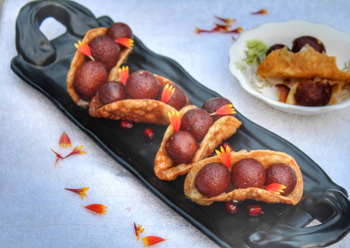 Warm gulab jamun in sweet crunchy tacos