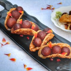 Warm gulab jamun in sweet crunchy tacos A picture of Warm gulab jamun in sweet crunchy tacos.