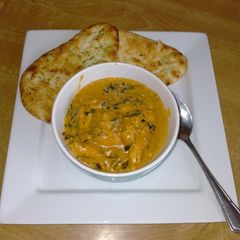 A picture of Chicken in Korma sauce with Spinach.