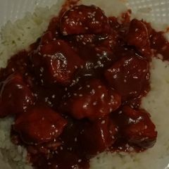A picture of Orange chicken over white rice.