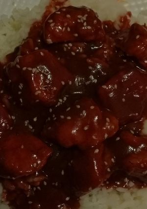 A picture of Orange chicken over white rice.