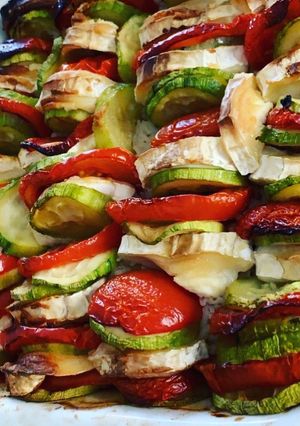 Une photo de Tian de tomates courgettes au chèvre sur lit de riz