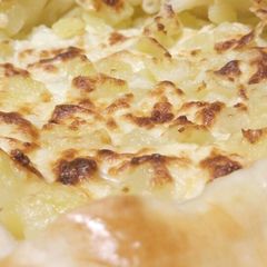 A picture of Rustic cheese and potato pie.