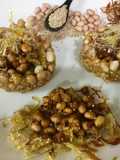 Caramalized peanuts in peanuts-sesame Katoris garnished with spun sugar