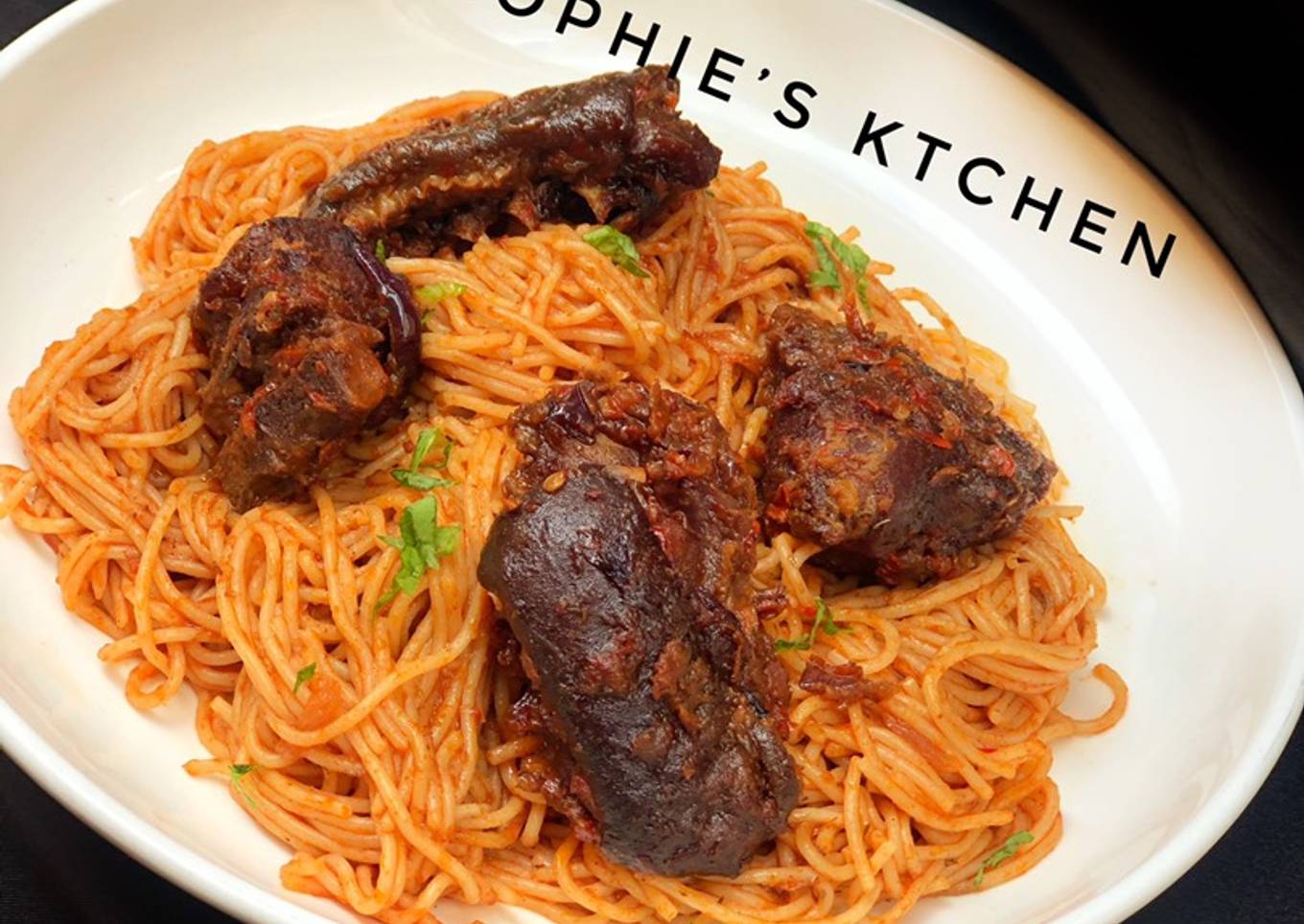 Pasta in tomato sauce with peppered goat meat