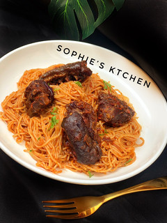 A picture of Pasta in tomato sauce with peppered goat meat.