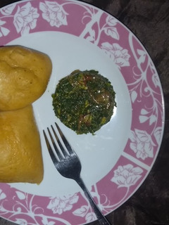 A picture of Moimoi with spinach sauce.