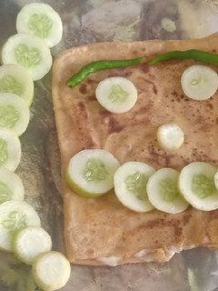 A picture of Cheese stuffed paratha with smile emoji.