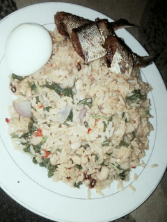 A picture of Jellof Rice and beans with spinach.
