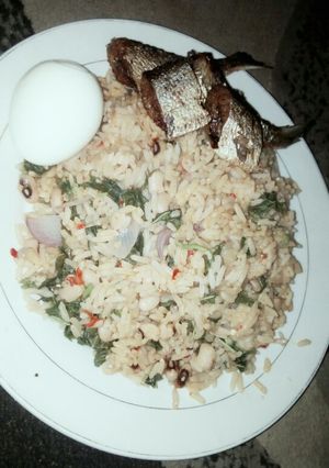 A picture of Jellof Rice and beans with spinach.
