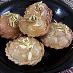 A picture of Coconut with malai khajur stuff gujiya.