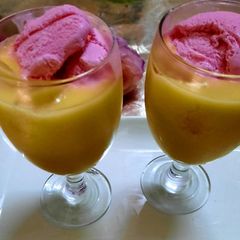 A picture of Mango 🥭 milk shake with strawberry ice cream 🍦.