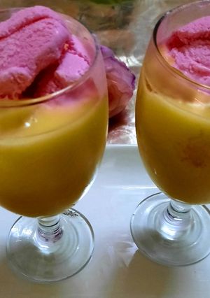 A picture of Mango 🥭 milk shake with strawberry ice cream 🍦.