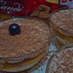 A picture of Tiramisu bowls with candi biscuit.