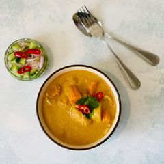 A picture of Chicken Thai yellow curry served with Ajard cucumber relish sauce.