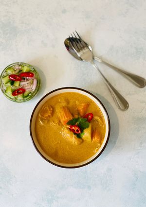 A picture of Chicken Thai yellow curry served with Ajard cucumber relish sauce.
