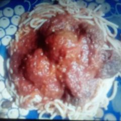 A picture of Spaghetti and baked cheddar and garlic turkey meatballs.