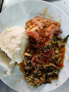 A picture of Stewed Chicken with Ugali and Cakales.