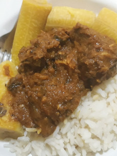 A picture of Rice with groundnut sauce and boiled plantain.