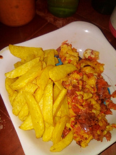 A picture of Fried Irish potatoes with fried eggs.