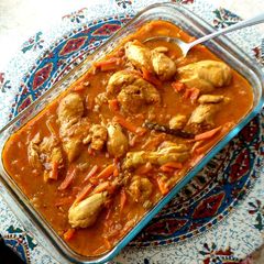 A picture of Chicken stew with pitted prunes and carrots.