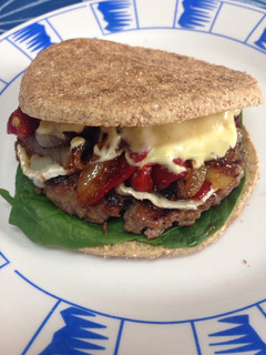 Una foto de Hamburguesa de ternera con queso de cabra y cebolla caramelizada con salsa de mostaza y curry
