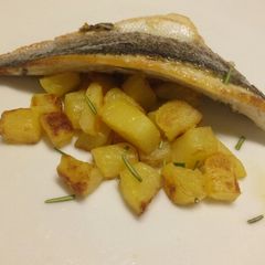 A picture of Lemon and rosemary pan fried sea bass with sautèed potatoes.