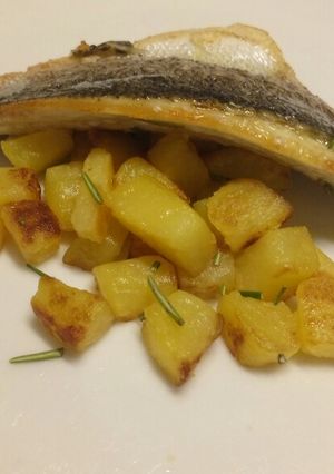A picture of Lemon and rosemary pan fried sea bass with sautèed potatoes.