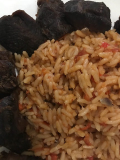 A picture of Jollof rice with fried beef.