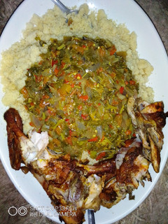 A picture of Couscous, vegetable soup and roasted chicken.