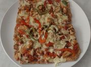 Una foto de pizza de pollo cocido