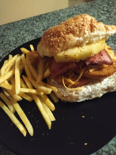A picture of Chicken and Pineapple Burger with thick cut pork rashers.