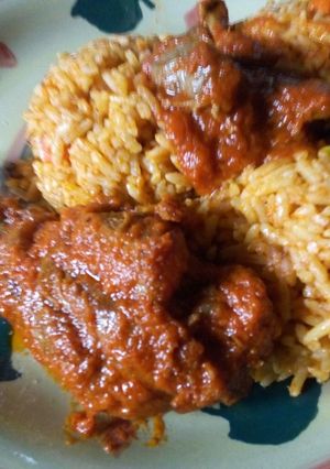 A picture of Vegetable Jollof rice with stewed chicken and gizzard.