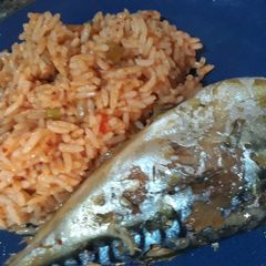 Jollof rice with fried fish A picture of Jollof rice with fried fish.