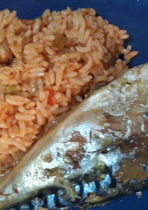 A picture of Jollof rice with fried fish.