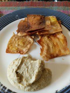 A picture of Hummus and chips.