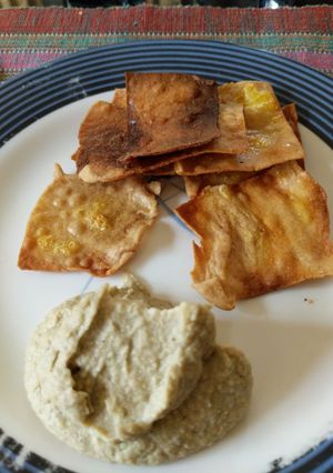A picture of Hummus and chips.