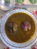 Whole onion in green leafy gravy