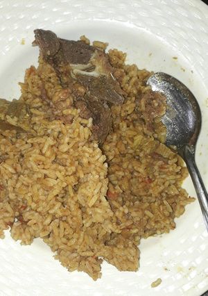 A picture of Cooked rice with beef.