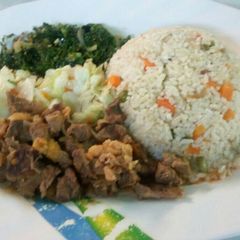Vegetable rice served with beef stew and vegetables A picture of Vegetable rice served with beef stew and vegetables.