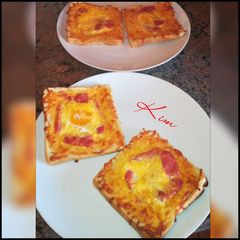 A picture of Cheesy egg in a hole baked toast.