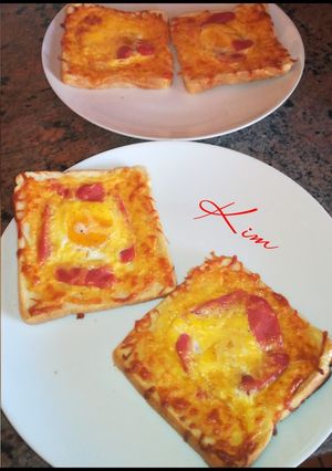 A picture of Cheesy egg in a hole baked toast.